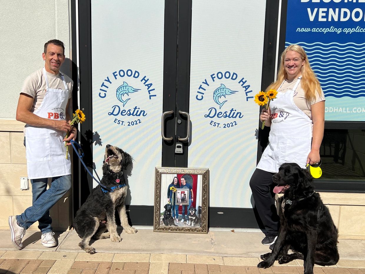 Phillip and Jessica Bauer outside of City Food Hall with their dogs