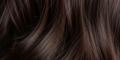 Close-up of shiny, smooth dark brown hair strands.