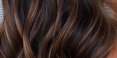 Close-up of wavy brown hair with subtle highlights.