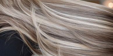 Close-up of smooth, shiny blonde hair with highlights.
