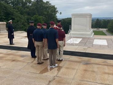 Group of people at a memorial or tomb site.