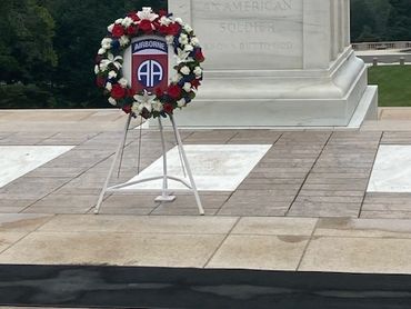 Wreath at a war memorial with inscription.