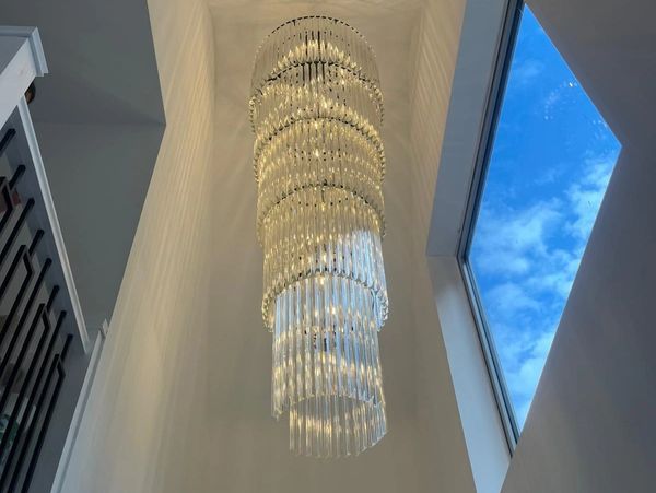 Modern glass spiral chandelier for staircases or foyers. Expertly installed by Simax Electrical.