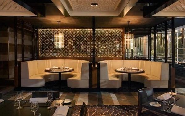 Elegant restaurant booths with warm lighting and modern decor.