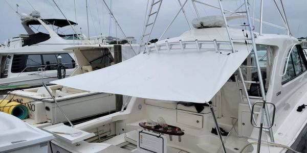 Boat docked with white canopy covering the seating area.