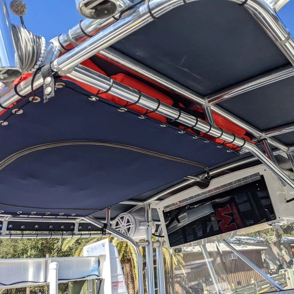 Boat canopy with mounted speaker and TV.