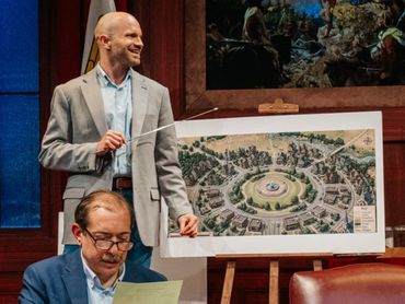 Man presenting a community layout design.