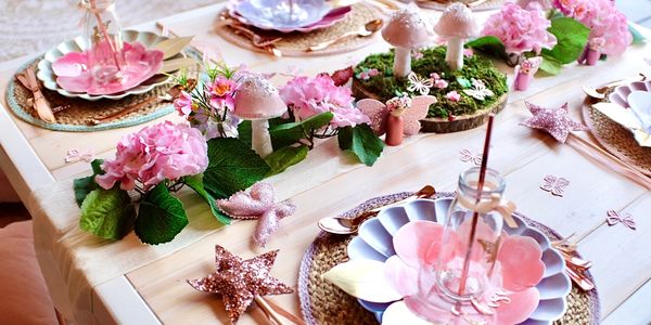 Bespoke magical fairy picnic party setup with tables for girls birthday celebration in Derbyshire.