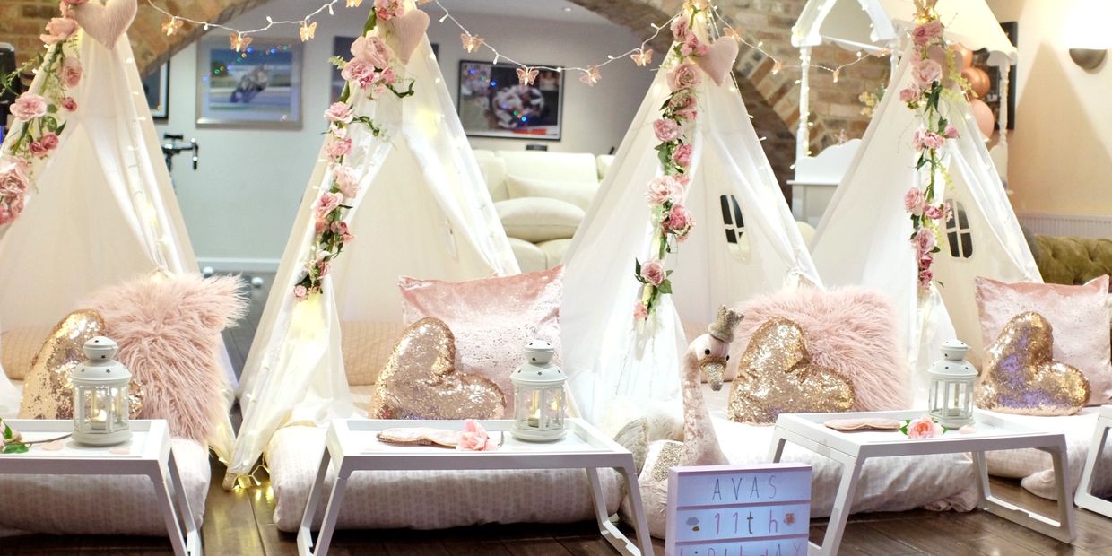 Boho Bliss teepee sleepover in pink and rose gold with floral garlands and elegant cushions in Derby
