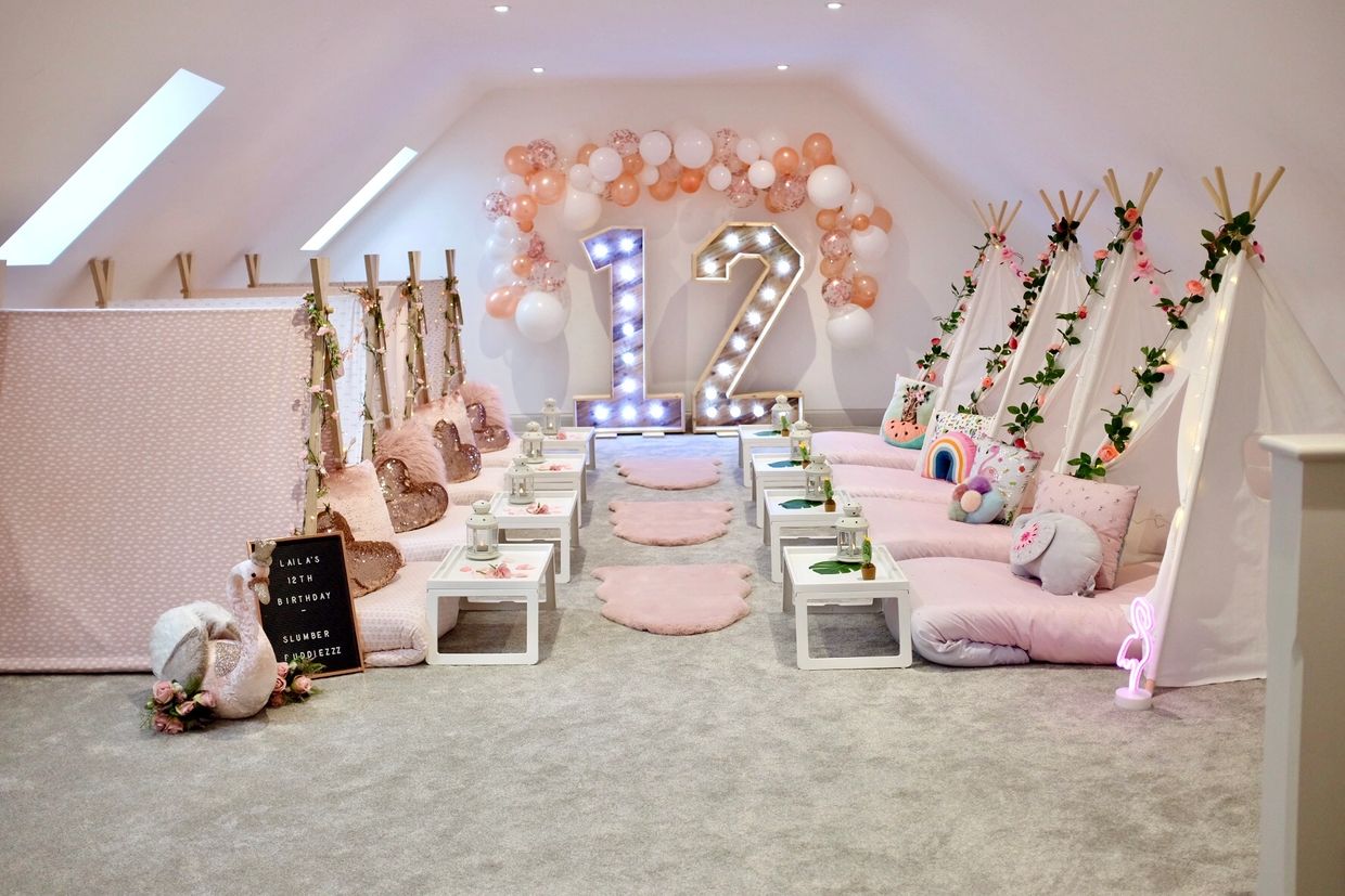 Magical birthday indoor teepee sleepover setup with tropical and boho decor, by Slumber Buddiezzz.