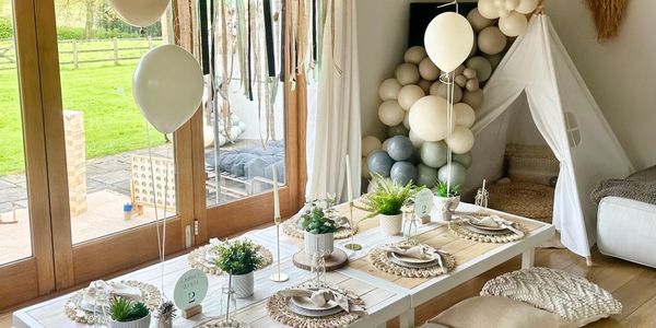 Chic indoor boho picnic setup featuring low tables, neutral tones, perfect for stylish celebrations.