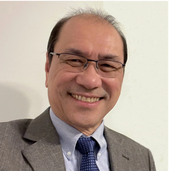 Smiling man in glasses wearing a suit and tie.