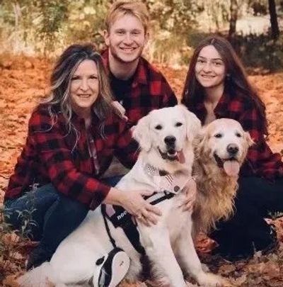 Three people with two dogs