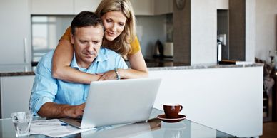 Man and woman looking at a laptop computer screen. Kitchen remodeling company Atlanta GA