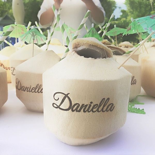 Coconuts with "Daniella" written, ready for drinking.