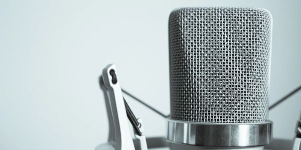 Close-up of a professional studio microphone with a metal mesh grille.