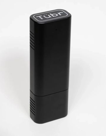 A sleek black device labeled 'Tübr' standing upright on a white surface.