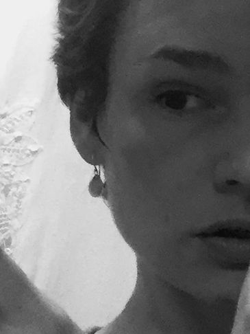 Black and white close-up of a person's face with a contemplative expression.