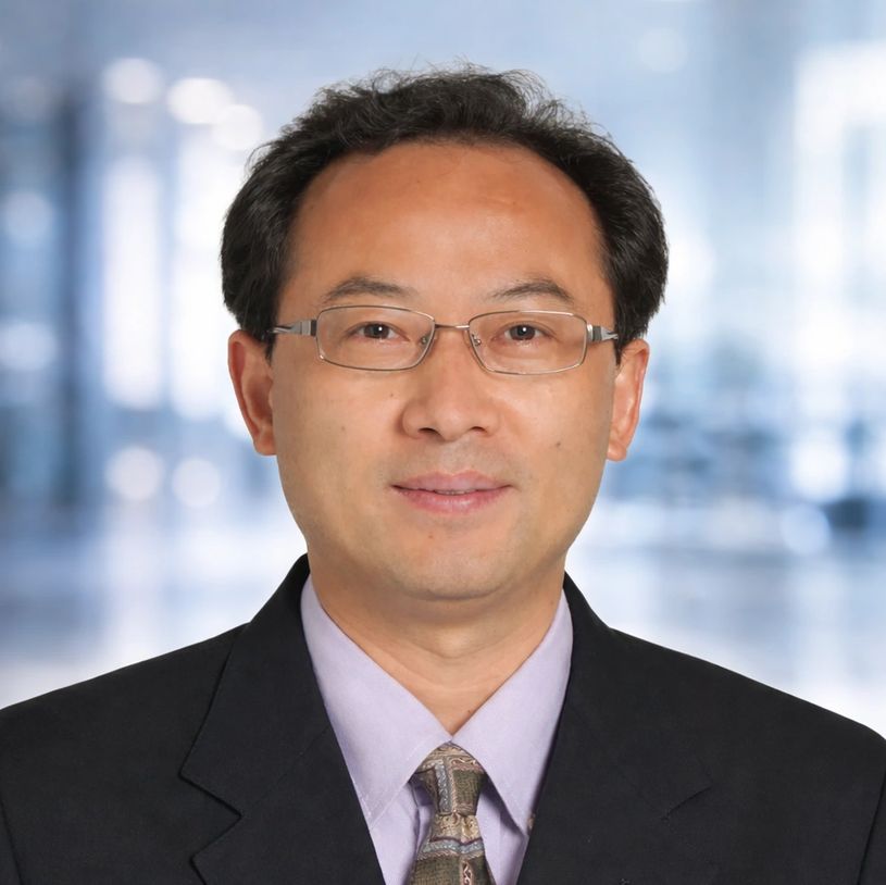 Professional man wearing glasses and a suit with a tie.