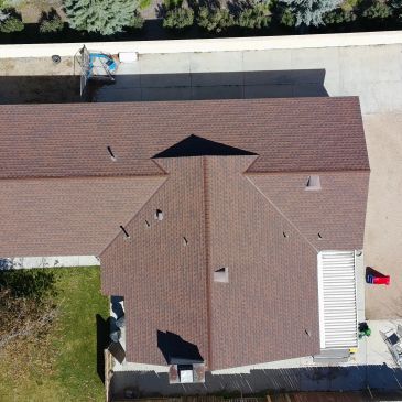 Aerial view of a house with a complex roof design.