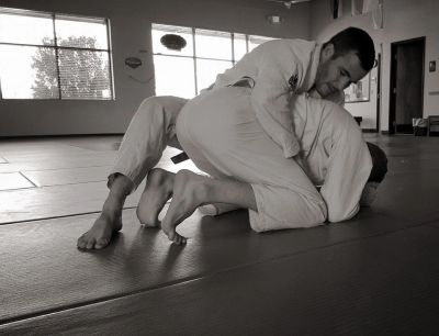Two men practicing Brazilian Jiu-Jitsu grappling.