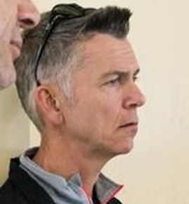 Profile of a middle-aged man with sunglasses on his head.