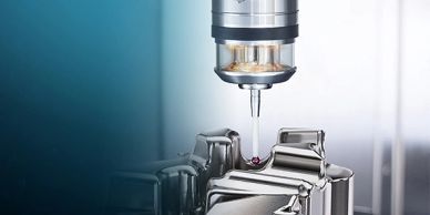A precision CNC machine tool working on a metal part with a cutting probe.
