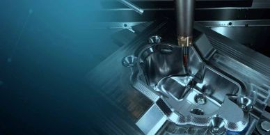 CNC machine precisely carving a metal mold for manufacturing.