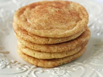 Stack of cinnamon sugar cookies on a decorative plate.