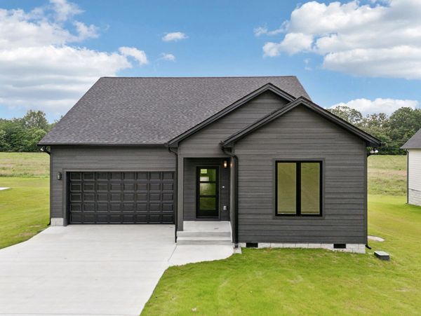 Modern dark gray house with a two-car garage.