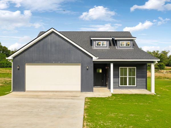 Modern grey house with white trim and a large garage.