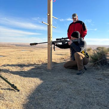 Student firing from an improvised tree.  kneeling out to 250 yards. Long range shooting training