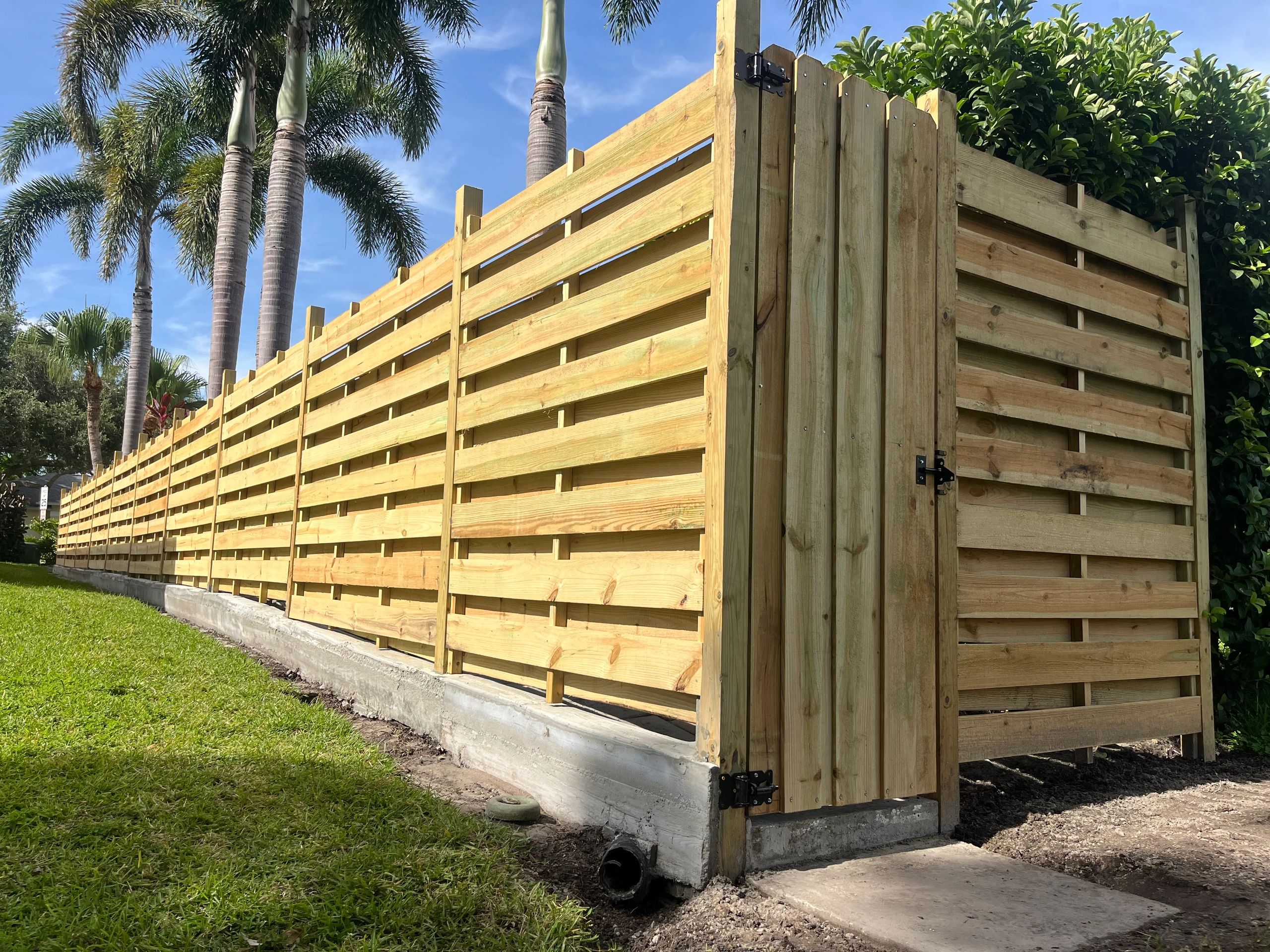 Concrete fence wall with horizontal shadowbox fence