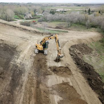 Excavating and grading. Building road and driveway. Dirt work.