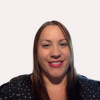Smiling woman with straight brown hair and red lipstick against plain background.