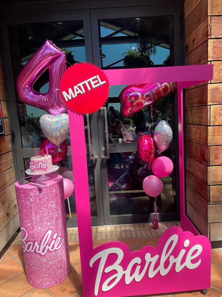Barbie-themed birthday setup with pink decorations and balloons.