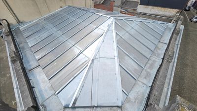 A newly installed metal roof with a triangular design.