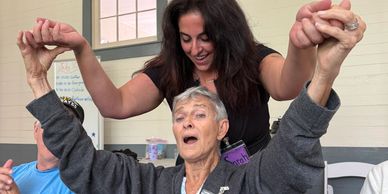A care partner and a member dancing