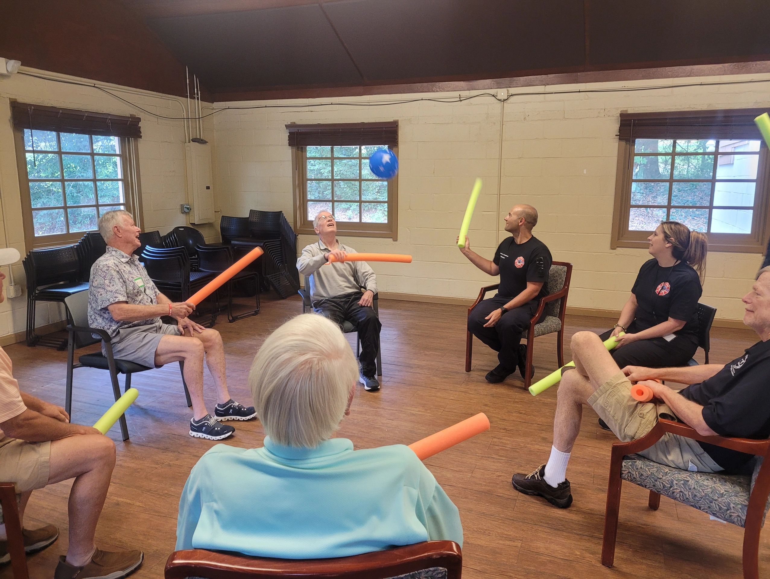 Participants doing exercises with pool noodle