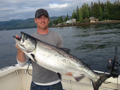Captain Ty with a chrome bright chinook (king) salmon while charter fishing in Ketchikan Alaska
