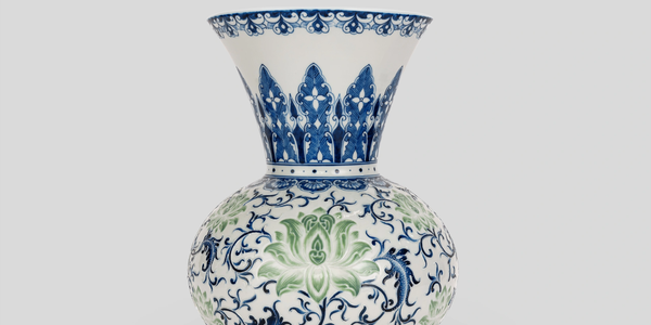 A decorative ceramic vase with blue and green floral patterns.