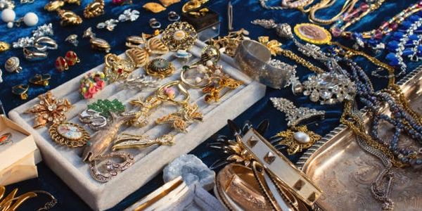 A collection of assorted jewelry displayed on a dark surface.
