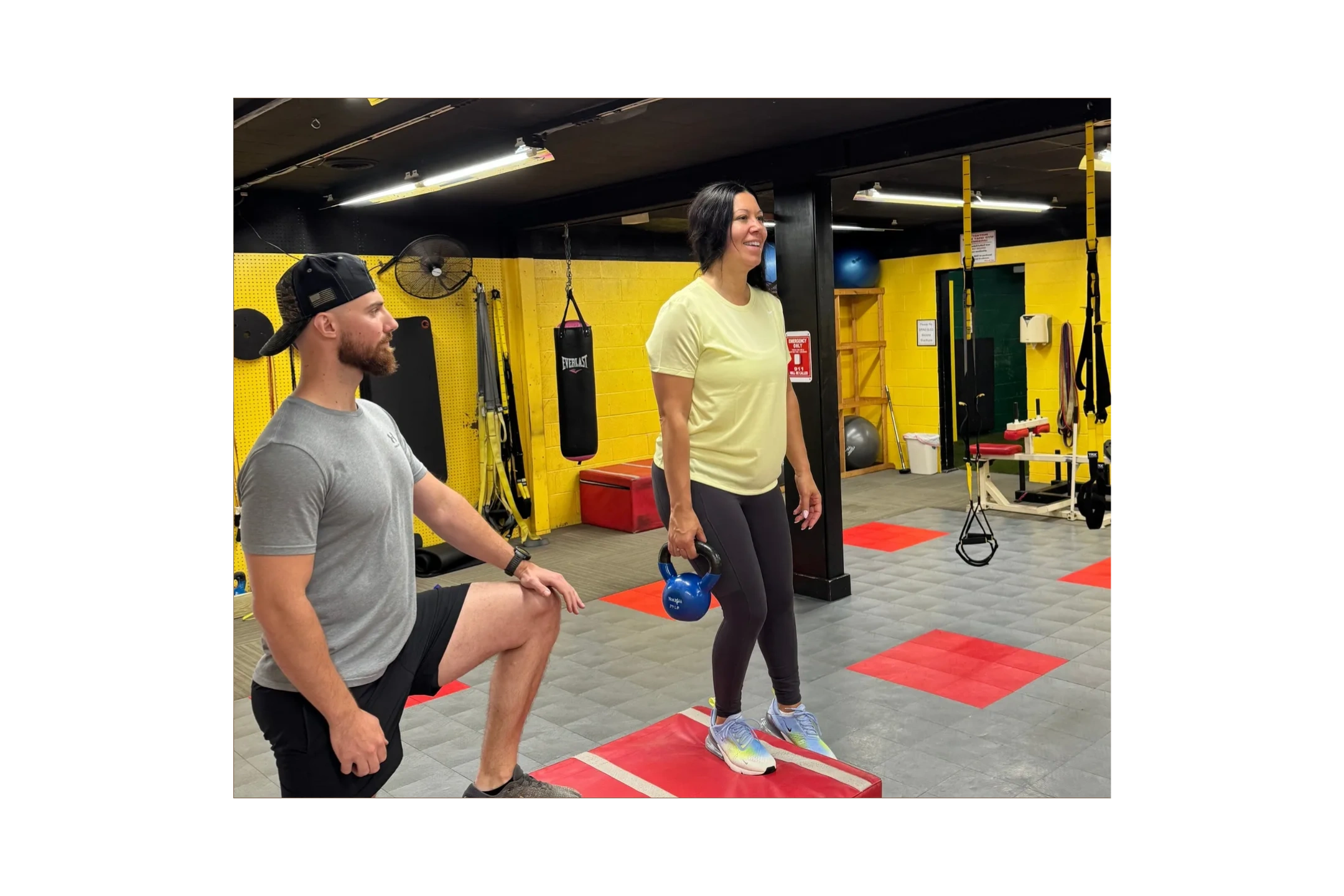 Personal trainer coaching a client through kettlebell exercises at Train Yard Gym in Harrisburg PA
