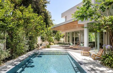 Modern house with pool and outdoor seating.