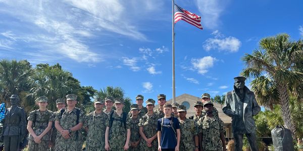 Lone Sailor Cadets in NWUs in at the Lone Sailor Memorial in Orlando, FL.