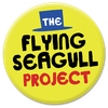 The Flying Seagull Project logo - a happy yellow badge with a small top hat icon