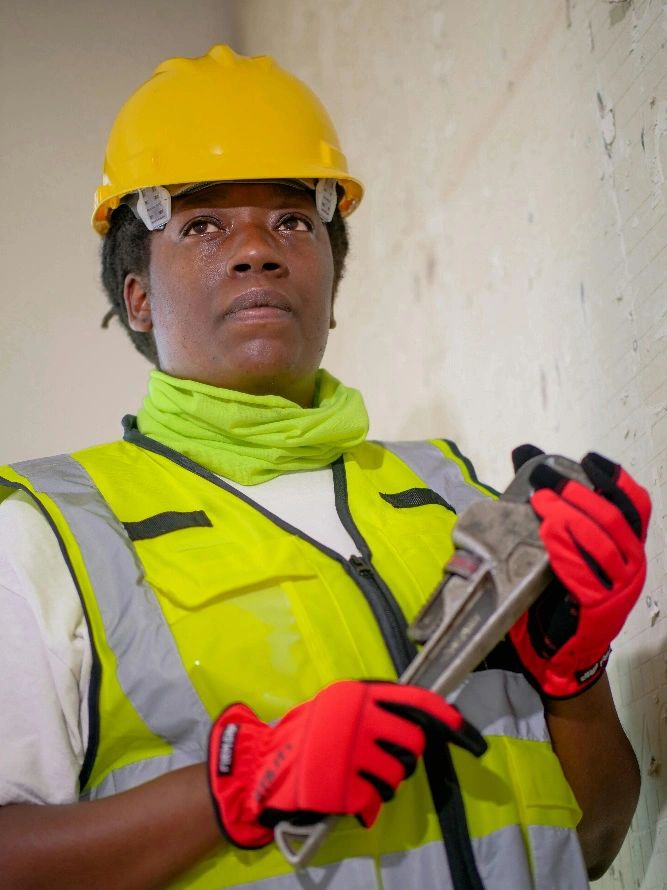 a woman holding a wrench