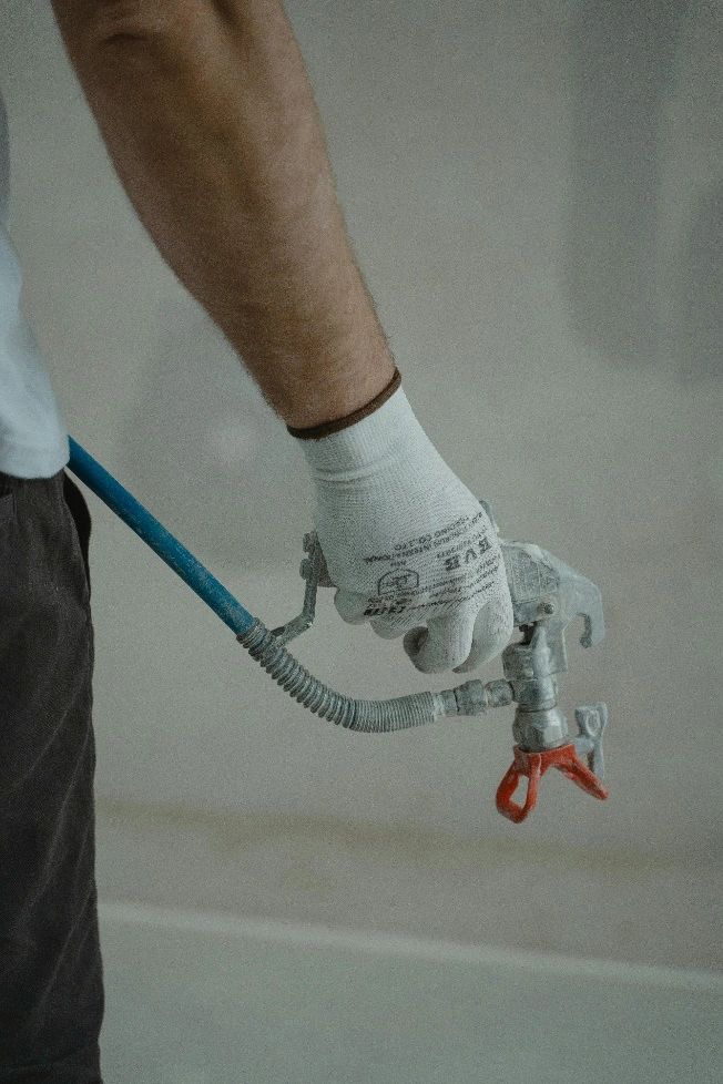  a plumber holding a silver faucet