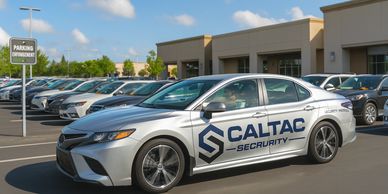 Security guard in Sacramento performing parking enforcement in a CALTAC Security Patrol Car