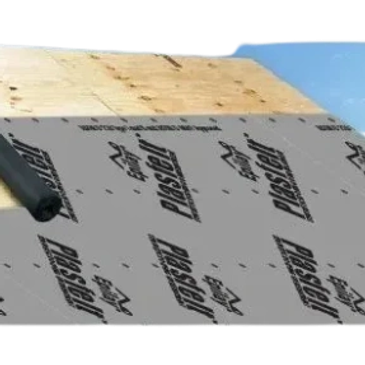 Roof underlayment being installed on wooden roof framing.